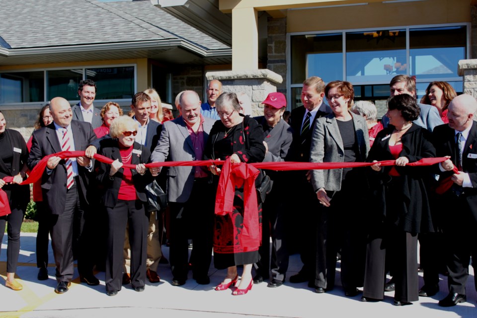 Patricia Gilbert cuts the ribbon at a grand opening event for the Gilda's Club location in Barrie on Sept 17, 2010.