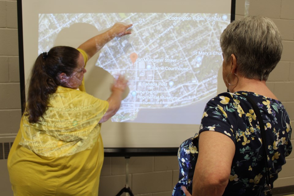 An official from the Canadian Mental Health Association (left) explains the preferred location for a proposed supervised consumption site in downtown Barrie during a drop-in meeting on May 15, 2019 at Collier Street United Church. Raymond Bowe/BarrieToday