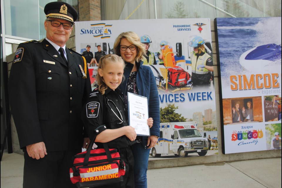 Paramedic Services chief Andrew Robert and her mom Sarah Flood wish her well. Laurie Watt for BarrieToday.com