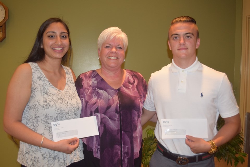 Lise McCourt, president of the RVH Auxiliary presented a $1,000 scholarship to RVH volunteers Ramneet Kaloti, a student at Innisdale Secondary School, and Cameron Weatherill, a Bear Creek Secondary School student. Supplied photo