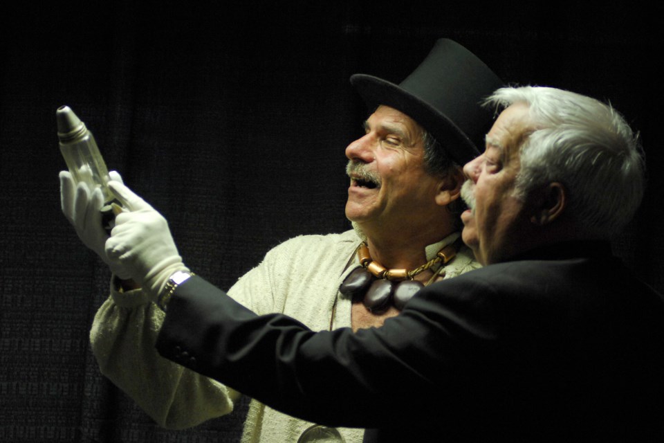 In this undated photo, Simcoe County Museum staff member Paul Rollinson, left, and former advisory committee chair David Walker look over an item during a previous Night at the Museum event. 