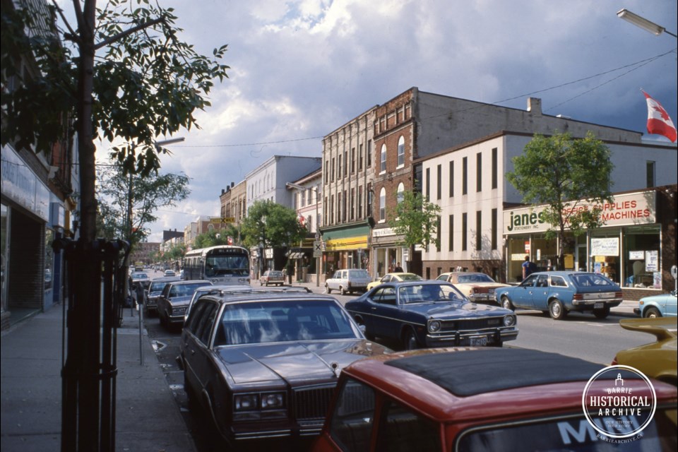 The white building to the left of Janes Stationary was once Livingston's, dealers in luxury cars like the Packard. Photo captured circa 1975.