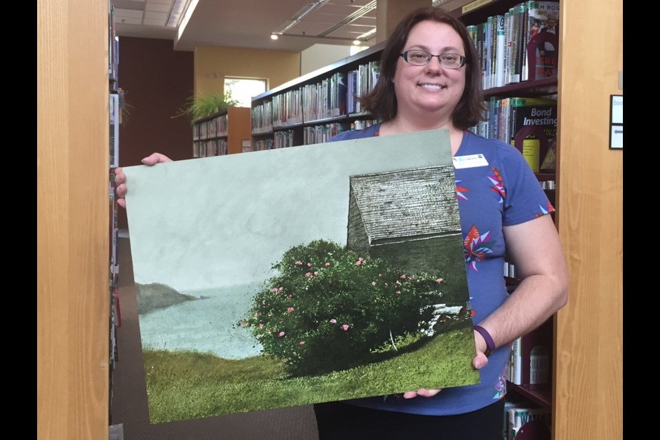 Genevieve Kwant, Barrie Public Library Manager of Branch and Public Services, holds the James Wyeth print that recently arrived back at the library after 31 years.  Sue Sgambati/BarrieToday