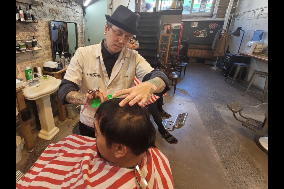 History Barbershop Co. manager Jody Percy tends to a client on Tuesday.