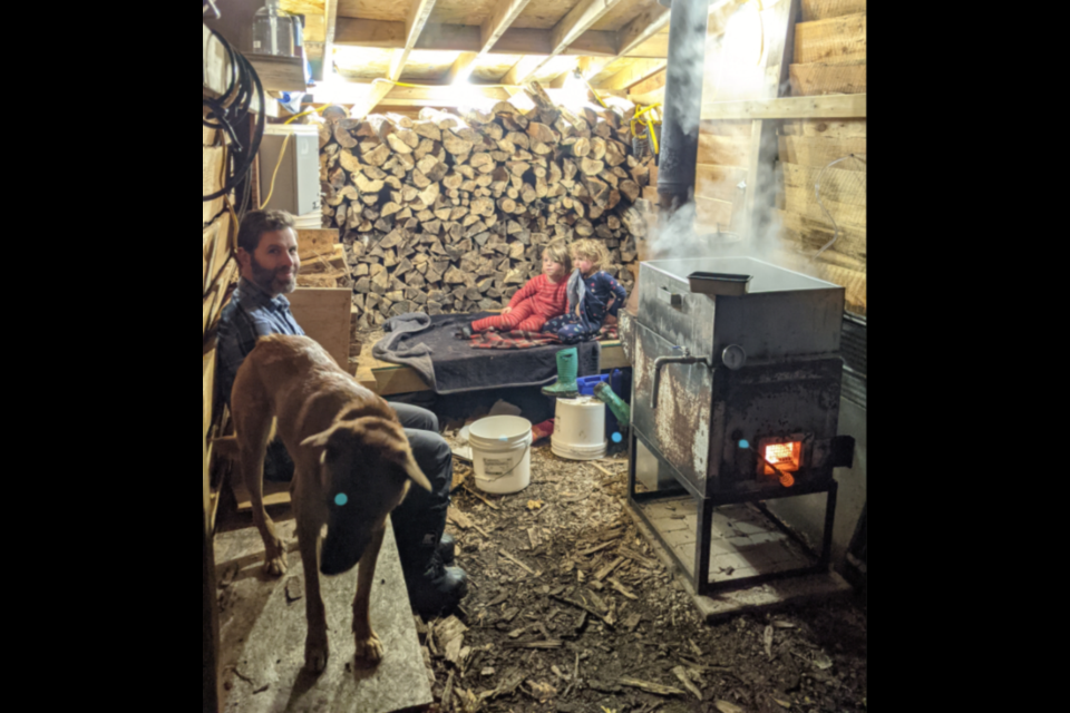 Scott LaMantia takes a break in the sugar shack on his property in Oro-Medonte's Sugar Bush community with his young children. 