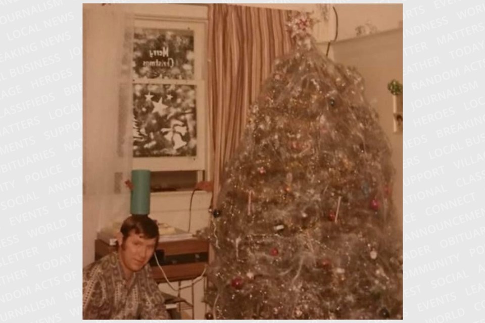 My dad with their heavily decorated Christmas tree in their Toronto apartment, shown pre-kids in January 1972. 