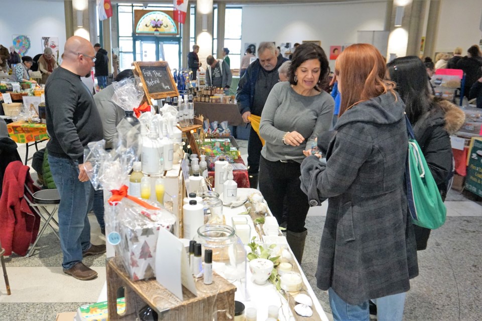 Denise Sutherland from Lotus Natural Living makes a sale during the Barrie's Farmers' Market on Saturday morning. Jessica Owen/BarrieToday                          