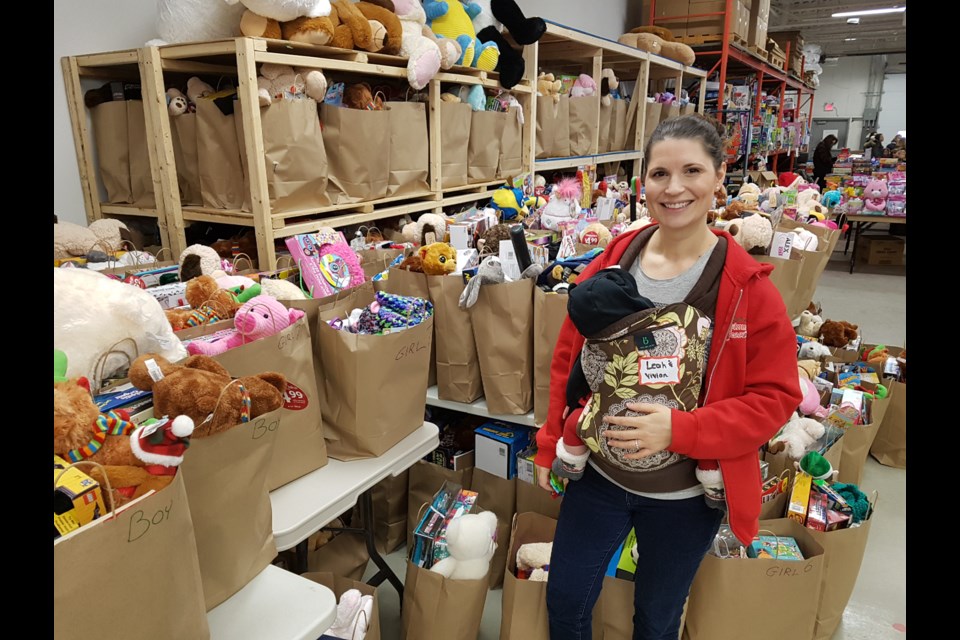 Christmas Cheer vice president Leah Wells and daughter Vivian get ready for a massive distribution effort in the coming days. Shawn Gibson/BarrieToday