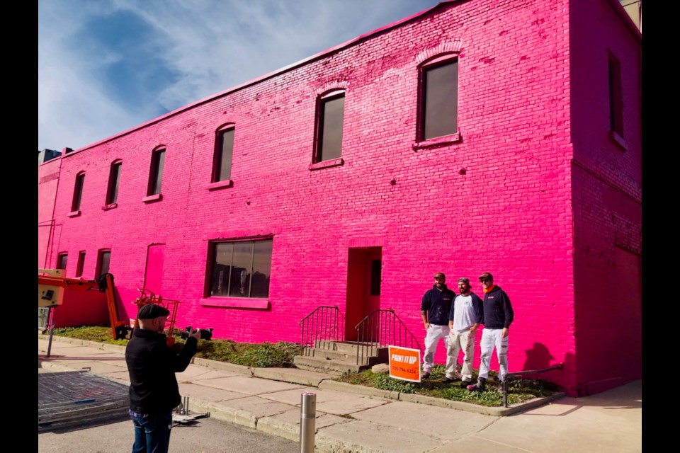 A long-empty building next to Meridian Place in downtown Barrie has been painted hot pink. 