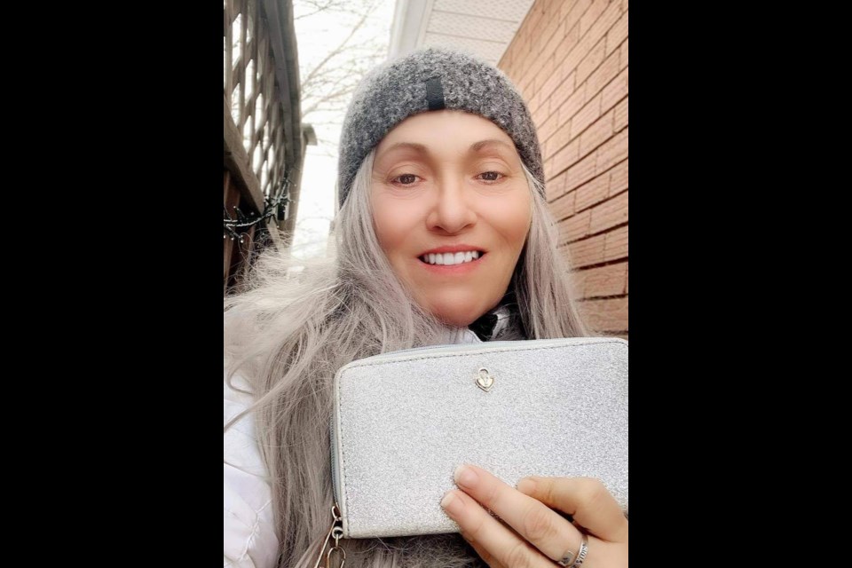 Kelly McCreight shows off her lost wallet that contained a special family keepsake. The east-end Barrie resident hopes to thank whoever dropped it in the mail slot.