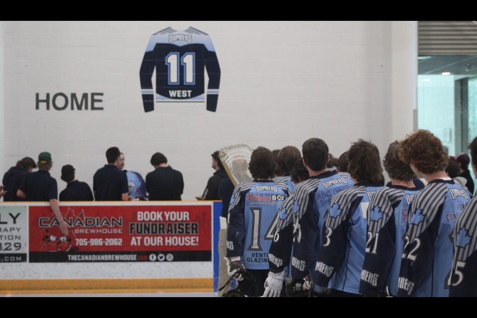 Players from the Barrie Bombers face the unveiling of Luke West's number 11 at the Peggy Hill Team Community Centre on Sunday, April 23.