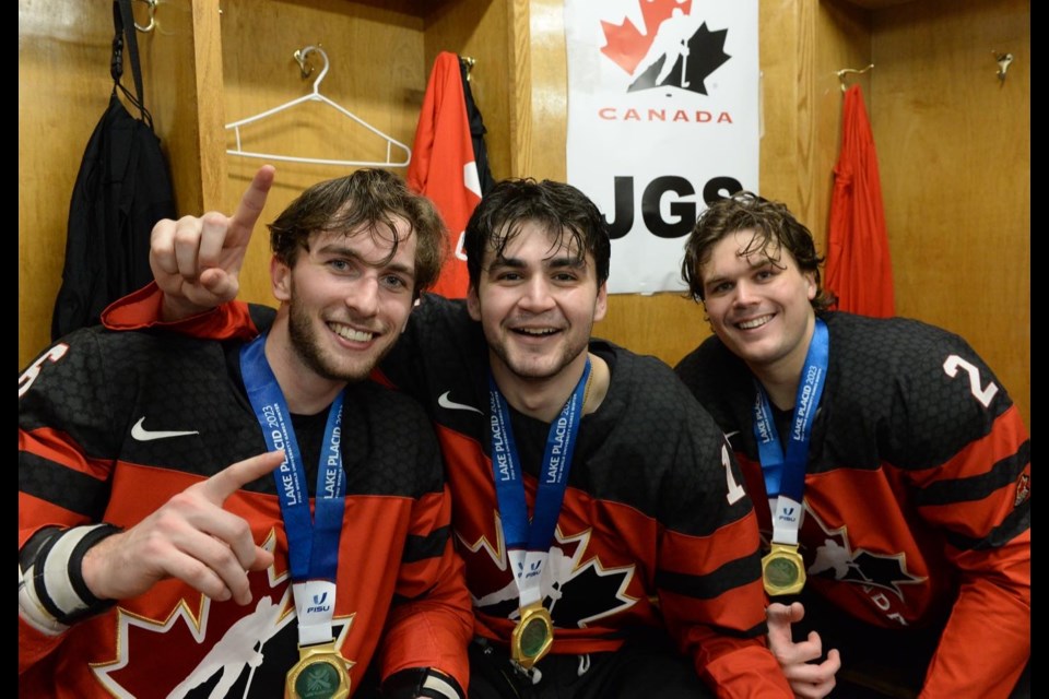 Barrie native Matt Brassard (right) celebrates a gold-medal win at the FISU Winter World University Games with his teammates.