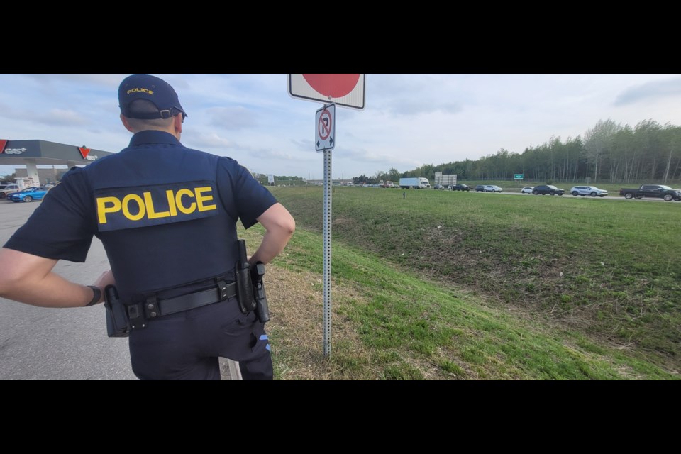 An OPP officer stands guard, watching for anyone not following the rules of the road, Friday.