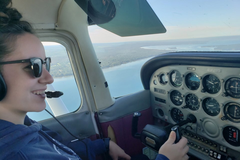 Former CFB Borden resident Meagan Daley is all smiles during her introductory flight in the Sault College aviation program earlier this year.