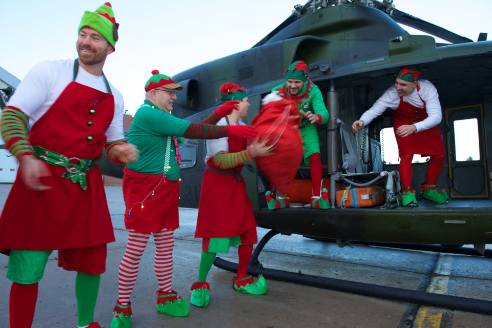 Elves from 400 Tactical Helicopter Squadron, Canadian Forces Base Borden, load a CH-146 Griffon helicopter with toys bound for the Hospital for Sick Children as part of Operation Ho-Ho-Ho on December 2nd, 2015. Photo courtesy Department of National Defense/Corporal Michael Terry