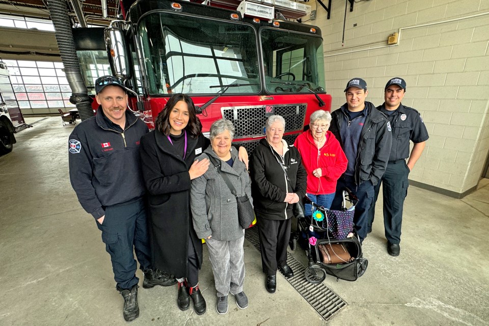 Firefighters from the fire station on Dunlop Street West downtown give a tour to Chartwell Allandale Station retirement residents after the ladies delivered them fresh-baked apple pies on Friday, March 22.