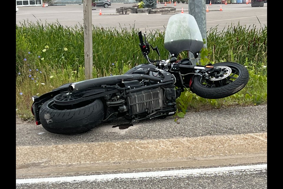 A crashed motorcycle lays on the side of the road following a collision in west-end Barrie, Tuesday morning.