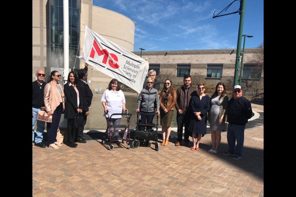 Andrea Butcher-Milne (center with white shirt) during the MS Month flag raising earlier this month.