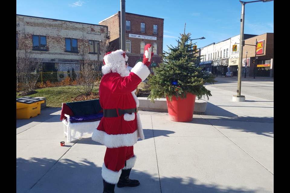 Santa Claus waves to the passers-by on Dunlop Street on a sunny Sunday afternoon, Saturday Nov. 30, 2019. Shawn Gibson/BarrieToday