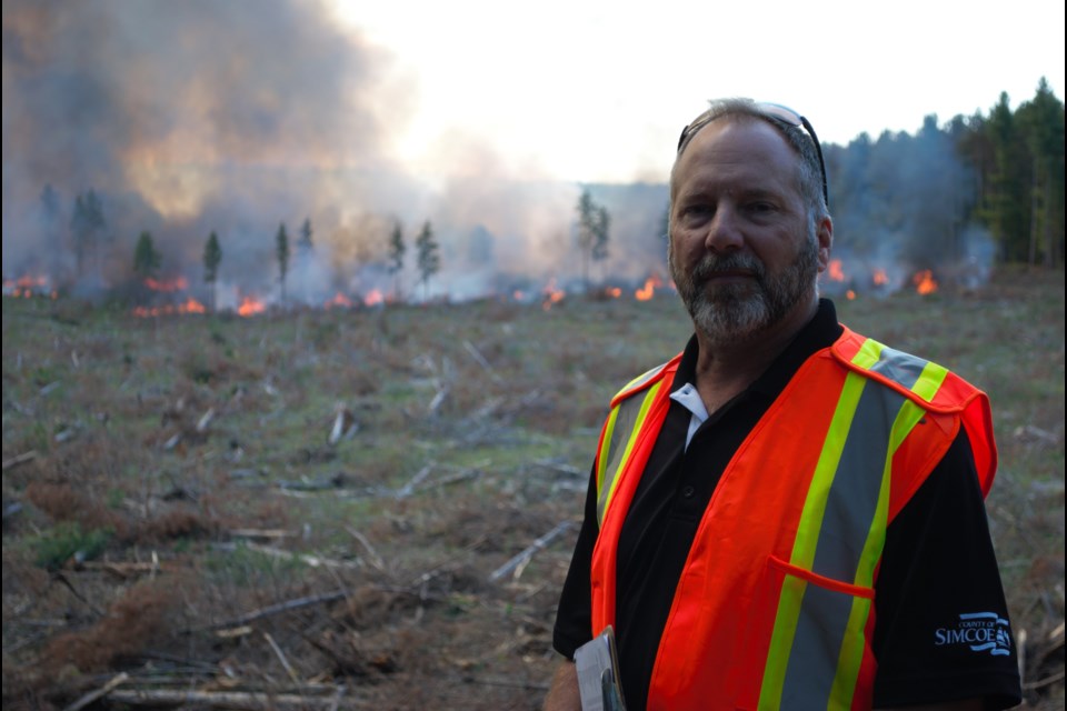 Graeme Davis, forester with Simcoe County, surveys a controlled burn in the Simcoe County Forest. Jessica Owen File Photo