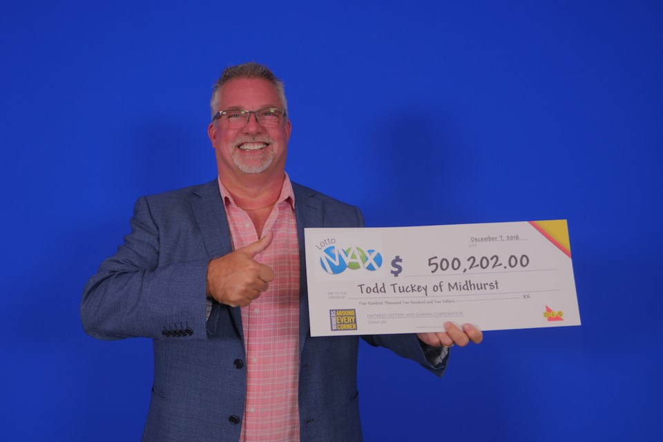 Midhurst resident Todd Tuckey with his big cheque. Photo provided by OLG