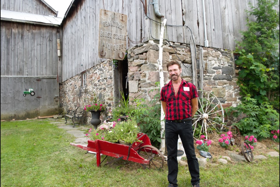 Neil Walker stands outside the part of the barn that houses Grandpa’s Horse Stable Antiques. Jessica Owen/BarrieToday 