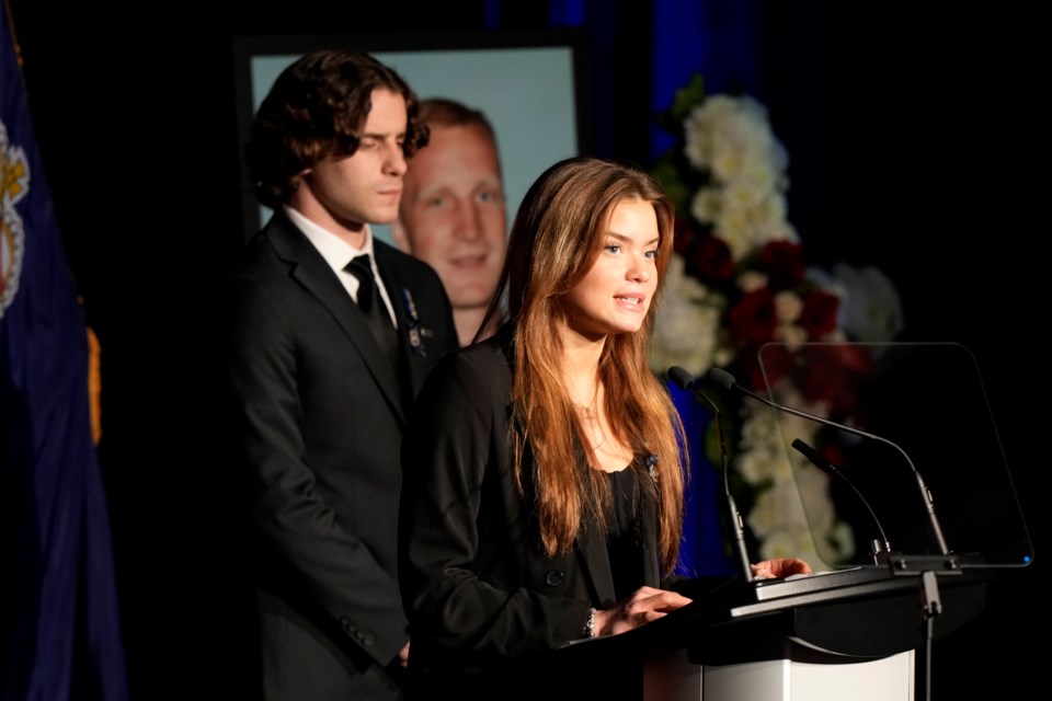 Justyna Pierzchala, sister of slain OPP Const. Greg Pierzchala, speaks during his funeral service in Barrie on Wednesday, Jan. 4, 2023 as her brother, Michal Pierzchala, looks on. 