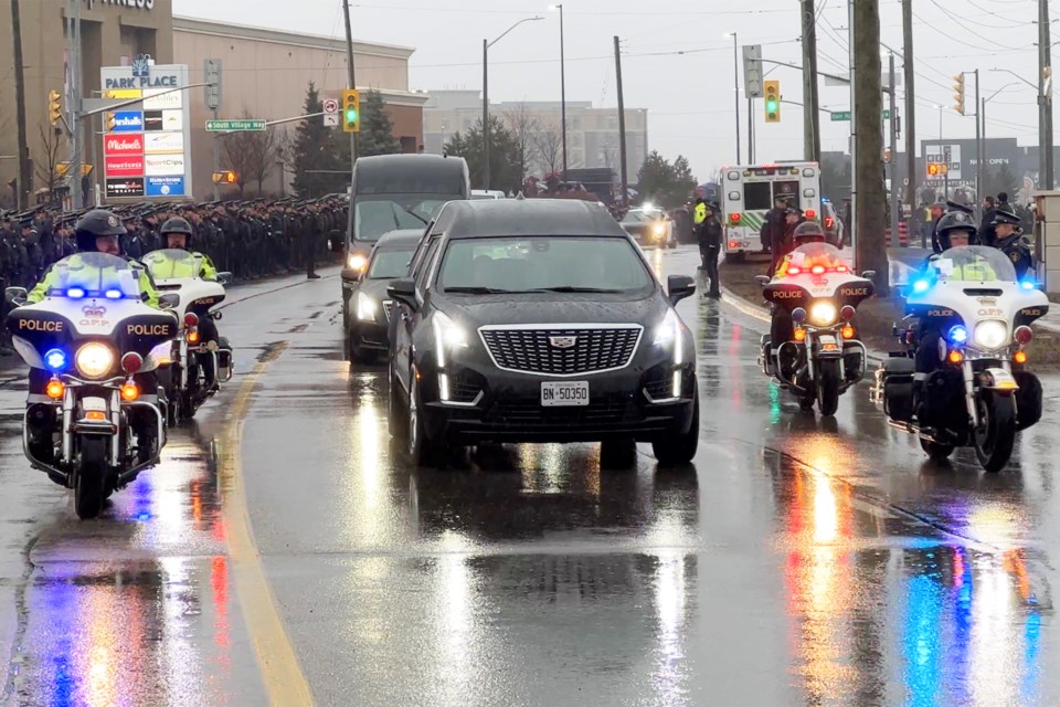 The hearse carrying the body of OPP Const. Greg Pierzchala, who was killed in the line of duty on Dec. 27, arrives at Sadlon Arena in Barrie for his funeral on Wednesday, Jan. 4, 2023.