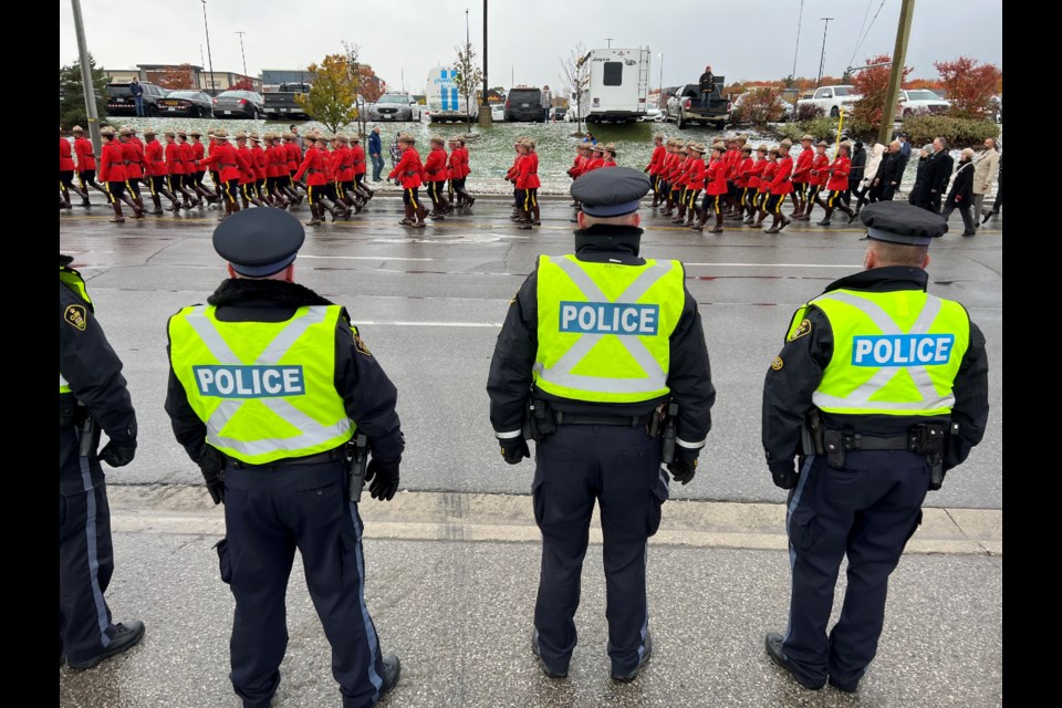 RCMP officers begin marching toward Sadlon Arena in south-end Barrie, Thursday morning, for the funeral of Const. Morgan Russell and Const. Devon Northrup, who were killed in the line of duty after being shot at an Innisfil home on Oct. 11.