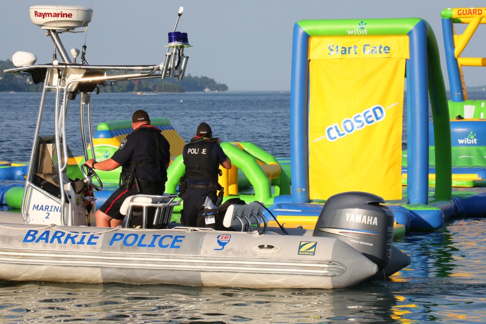 Barrie police officers investigate at Centennial Beach around the inflatable water park on Sunday, July 15, 2018. Kevin Lamb for BarrieToday.