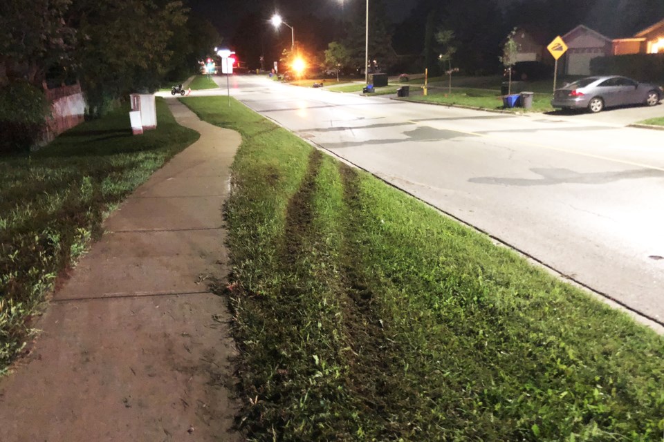 Marks left in the grass show where a Tesla lost control and left the road prior to coming to rest at Assikinack Public School after it jumped the steep railroad crossing on Little Avenue at 8:30 p.m. on Aug. 28, 2018. Kevin Lamb for BarrieToday.