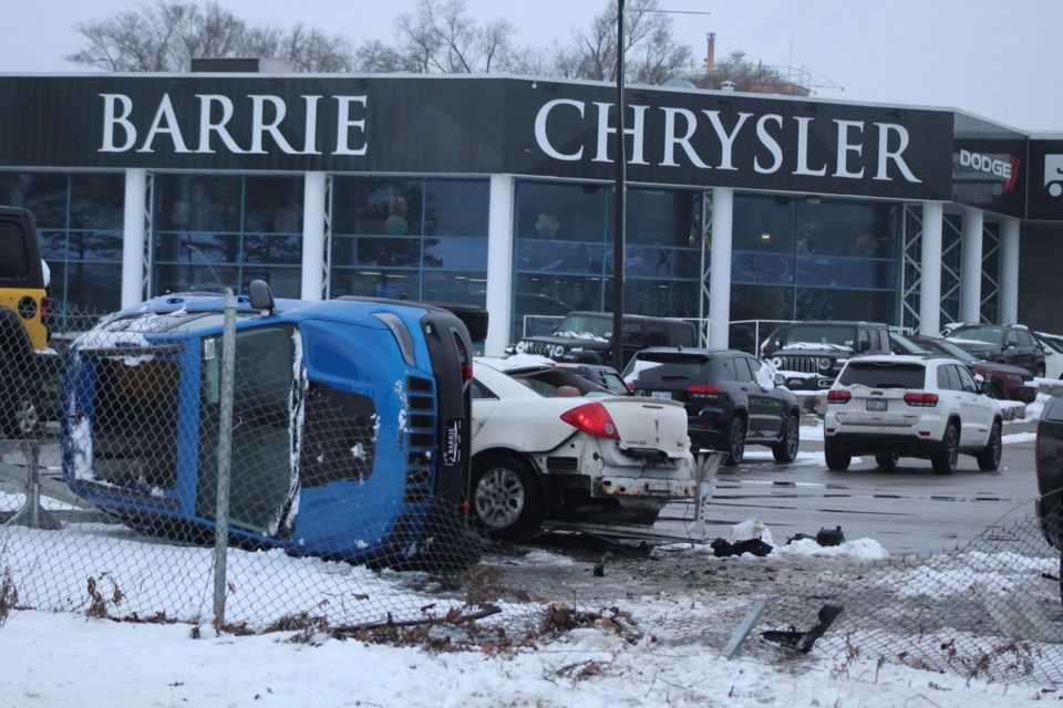 A small white Pontiac crashed into the Barrie Chrysler dealership, damaging a blue Jeep on the lot, following a crash at the Dunlop Street exit from Highway 400 southbound on Thursday, Dec. 13, 2018. Raymond Bowe/BarrieToday