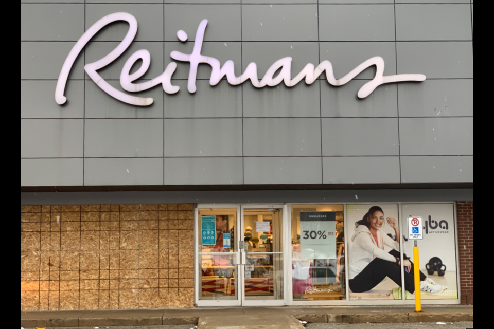 The front of Reitmans is boarded up after a car drove through it on Tuesday, Nov. 30, 2021.