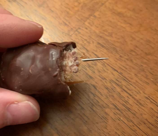 Jessica Carole shows the sewing needle sticking out of a chocolate bar her daughter received on Halloween. Photo supplied