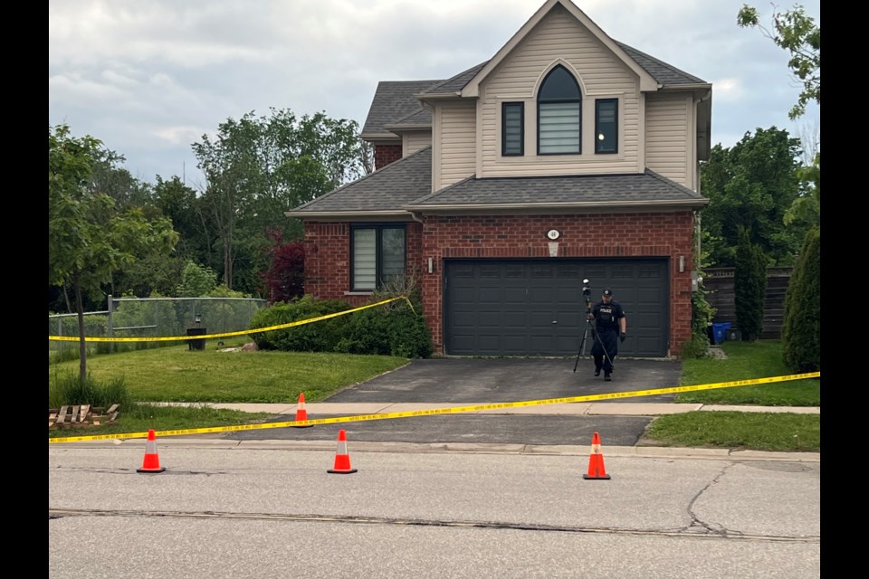 Barrie police collect evidence in front of a home on Country Lane, in the city's south end, following a shooting on Tuesday, June 7, 2022. 