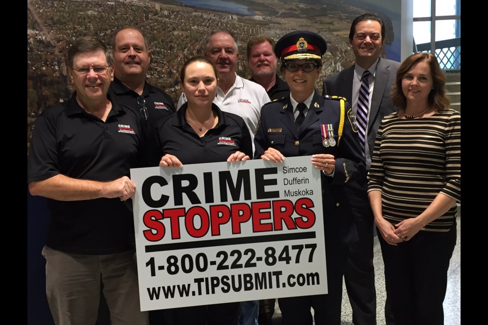 New Crime Stoppers signs: Mayor Jeff Lehman, Chief Greenwood, Crime Stoppers SDM president Rick Dodd, OPP Const. Chris Lewis, Colleen Wise, Brian Morris, Jim Parker and Jessica Dodd - also of the Crime Stoppers SDM - show off one of the new signs in Barrie.
Sue Sgambati/BarrieToday