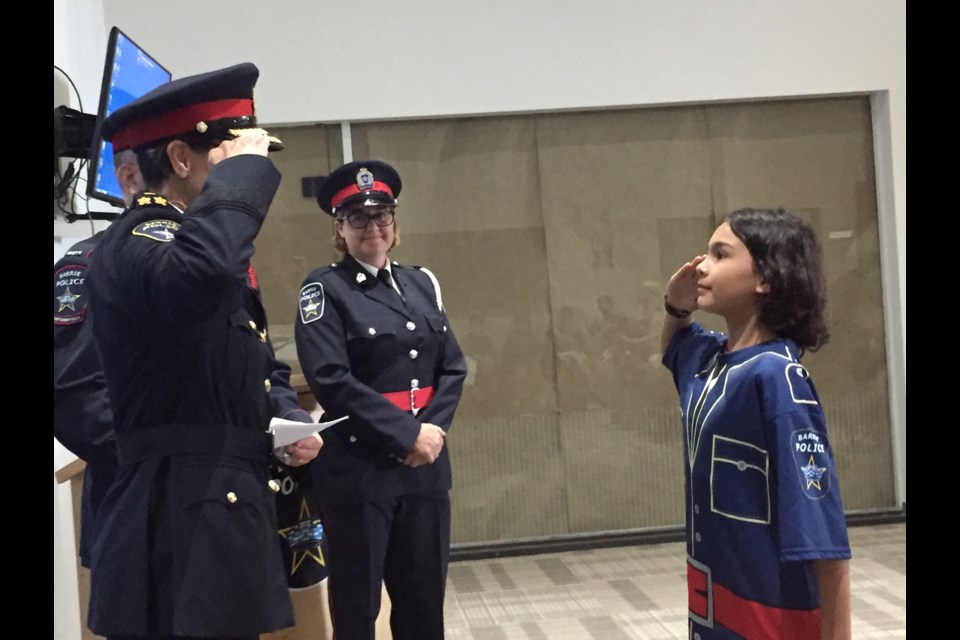 Junior Constable Sierra salutes Barrie Police Chief Greenwood at the camp graduation ceremony.  Sue Sgambati/BarrieToday
