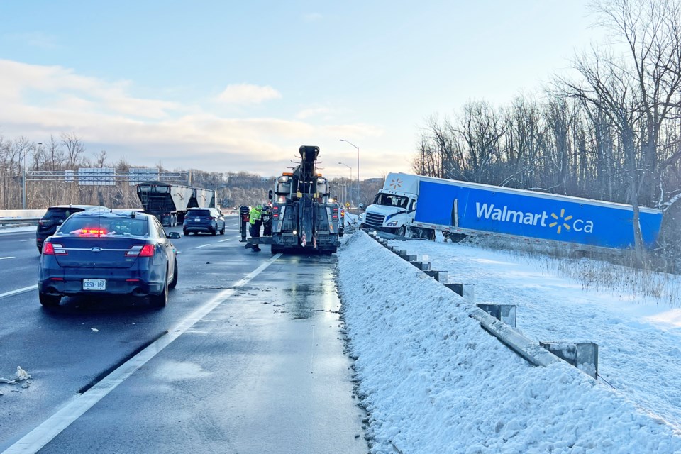 Traffic was backed up Sunday afternoon as a tractor-trailer broke through the guide rail of the southbound ramp near the Highway 400-11 split.