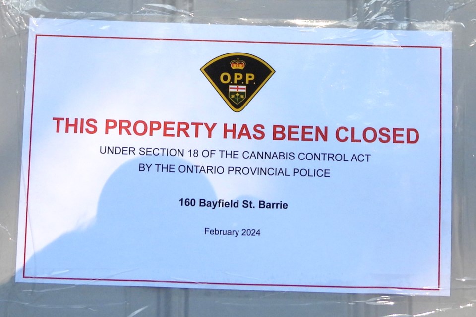 A sign taped to a door at 160 Bayfield St. in Barrie after an Ontario Provincial Police raid on Feb. 6 on seven stores across Greater Toronto Area yielded $600,000 worth of drugs, mainly cannabis. Bayfield Bongs on Bayfield Street in Barrie was one of the stores involved in the raid.