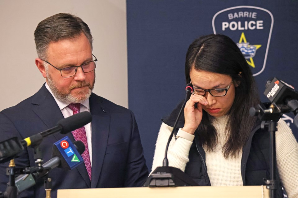Lili-Anne Moore, the sister of Autumn Shaganash, tears up during a news conference at Barrie police headquarters on Thursday, Feb. 8. Police are offering a $50,000 reward to help find Shaganash, who has been missing since June 2023. Moore is shown with Barrie police communications co-ordinator Peter Leon.