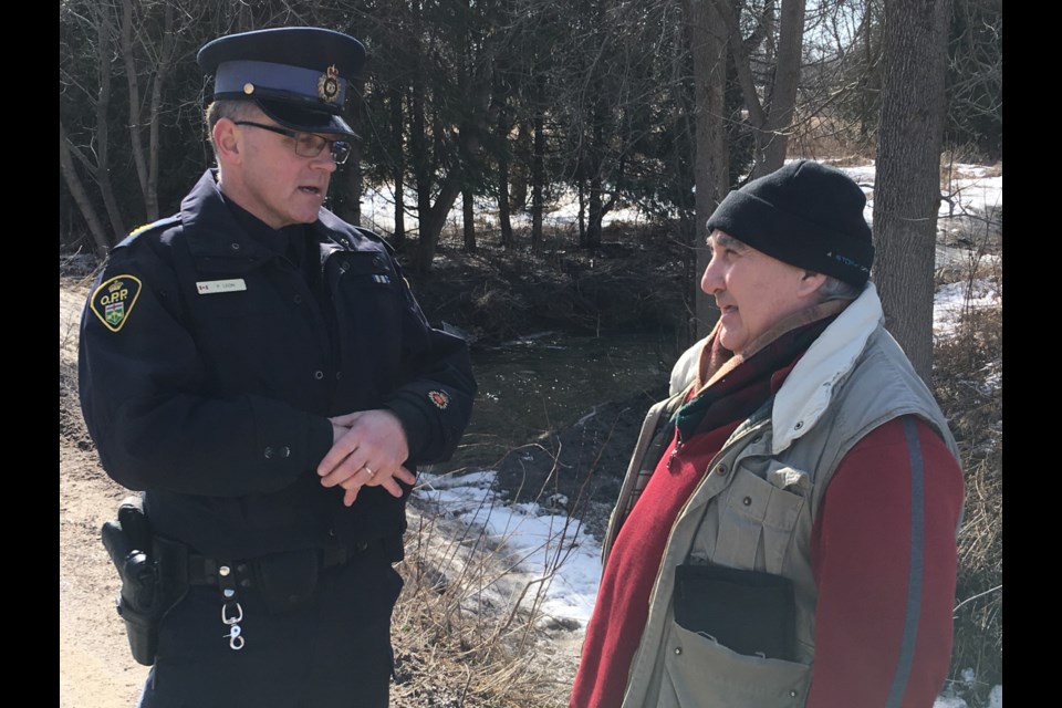 OPP Sgt. Peter Leon speaks to local resident Raymond Dumont after human remains were found Tuesday morning at Heritage Hills Golf Club, north of Barrie. Raymond Bowe/BarrieToday