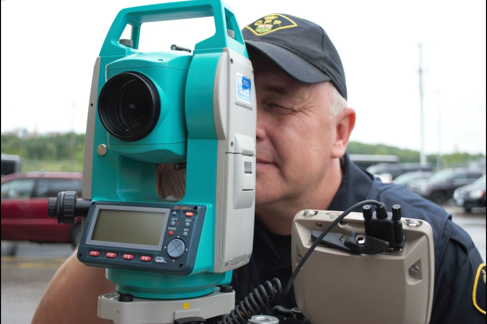 Const. Marko Harjupanula operates a theodolite, used by the OPP's collision reconstruction unit to create a forensic map of a collision scene. Jessica Owen/BarrieToday