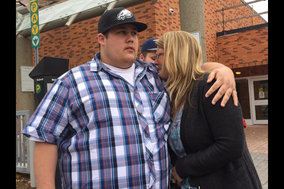 Tanya Gaston weeps as son Josh comforts her following the conviction of a New Tecumseth man in  impaired driving death of Geoff Gaston. Son Tim is in the background. 
Sue Sgambari/BarrieToday