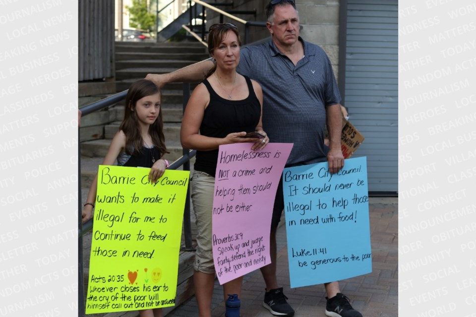 Protesters gathered outside Barrie City Hall on Wednesday evening to rally against the homelessness action plan. 