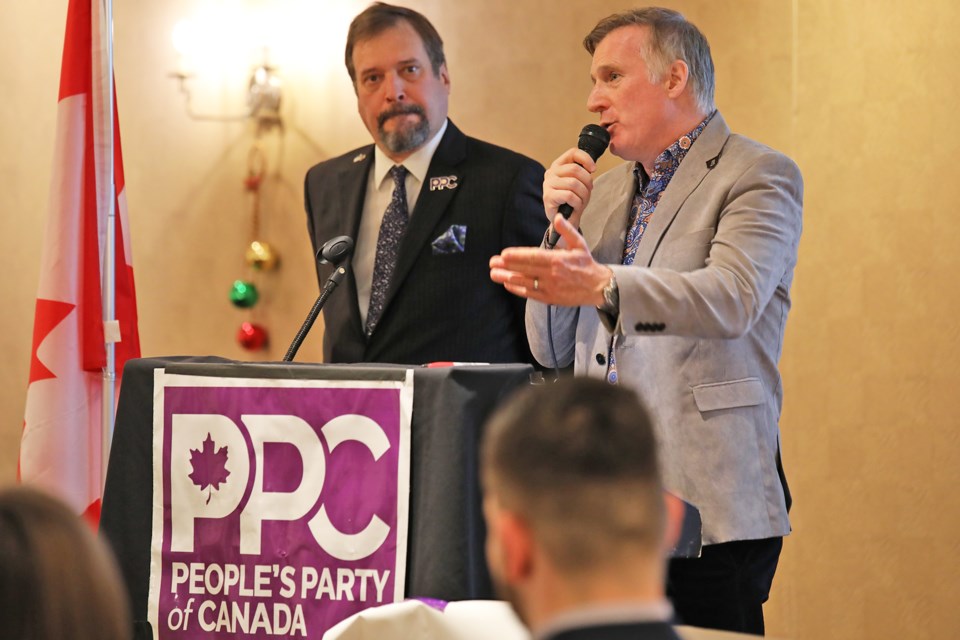People's Party of Canada leader Maxime Bernier, right, addresses the crowd gathered for their annual meeting, held in Barrie on Sunday, Nov. 27, 2022.