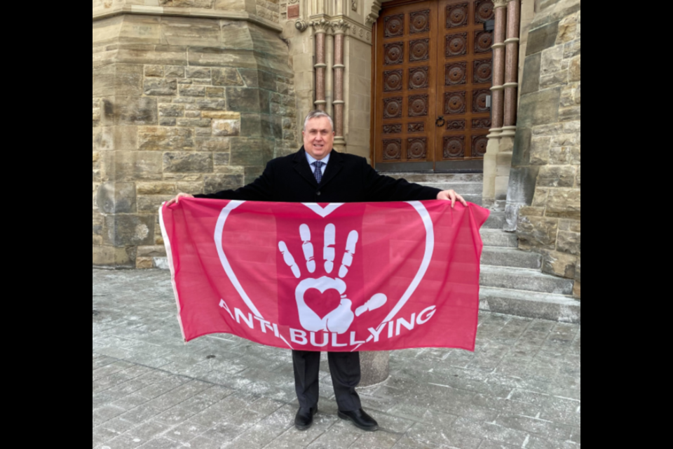 Barrie-Springwater-Oro-Medonte MP Doug Shipley holds an anti-bullying flag in Ottawa. 