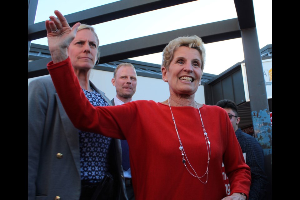 Liberal Party of Ontario leader Kathleen Wynne waves to supporters while leaving a campaign event in north-end Barrie, Thursday. Wynne was in town to officially open Barrie-Springwater-Oro-Medonte candidate Jeff Kerk's campaign office. Kerk is shown in the background. Raymond Bowe/BarrieToday