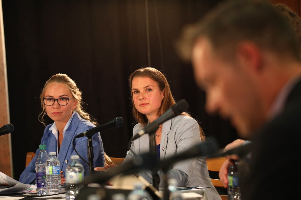 Trillium Party candidate Stacey Surkova, left, and PC candidate Andrea Khanjin listen to their opponents speak during the candidates debate held at Georgian Downs on Wednesday, May 30, 2018. Kevin Lamb for BarrieToday.