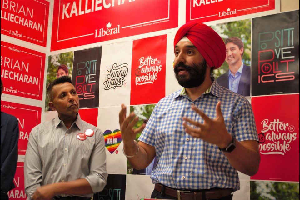 Federal minister of innovation, science and economic development and member of parliament (MP) Navdeep Bains speaks while Brian Kalliecharan looks on at his official campaign launch event at 181 Livingstone St. E. on Sunday morning. Jessica Owen/BarrieToday