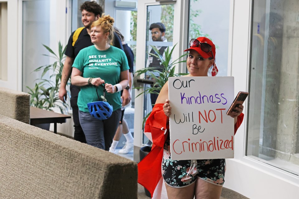 Protesters enter the council chamber at Barrie City Hall, Wednesday night, to voice their displeasure over the new plan to address homelessness. 